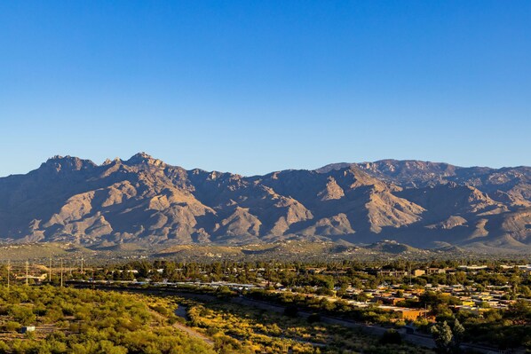 A mountainous landscape with a town in the foreground. - Hilton Tucson East (Tucson)
