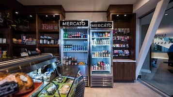 A Mercato food display with various food items and a refrigerated section with beverages and snacks.