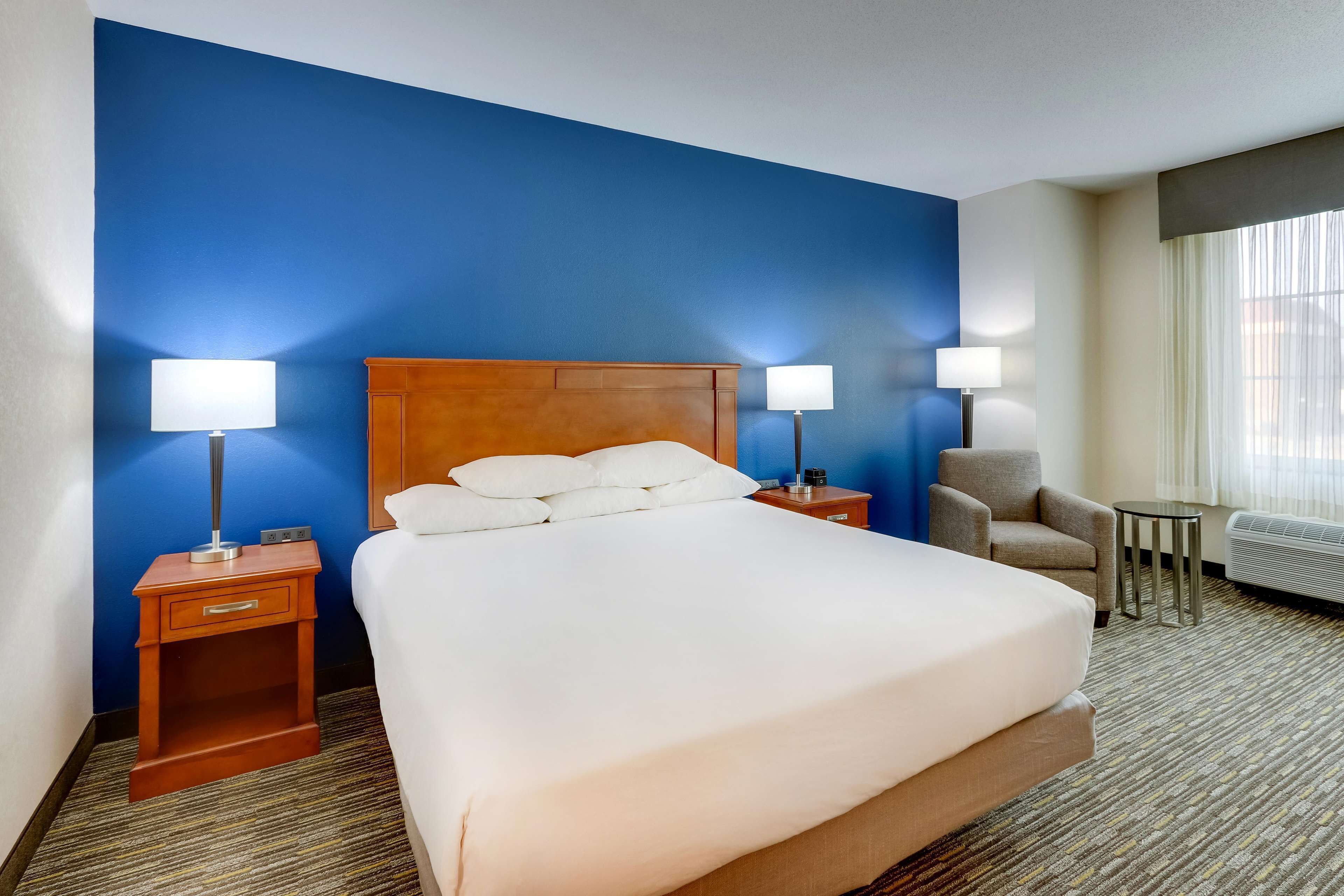 deluxe room, 1 king bed, accessible, refrigerator & microwave (roll in shower) | desk, blackout curtains, iron/ironing board, free cots/infant beds