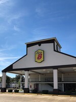 A building with a prominent sign reading "Super 8 by Wyndham" on the facade.