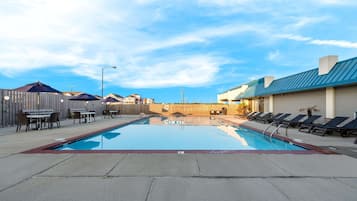 Seasonal outdoor pool, open 10:00 AM to 10:00 PM, pool umbrellas