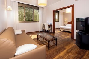 Family Room, Multiple Beds, Non Smoking (Converts to 2 Twin Beds) | Living area | 32-inch flat-screen TV with satellite channels, TV