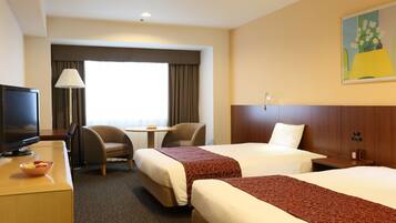 A hotel room with two beds, a desk with a TV, a chair, a lamp, and a painting on the wall.