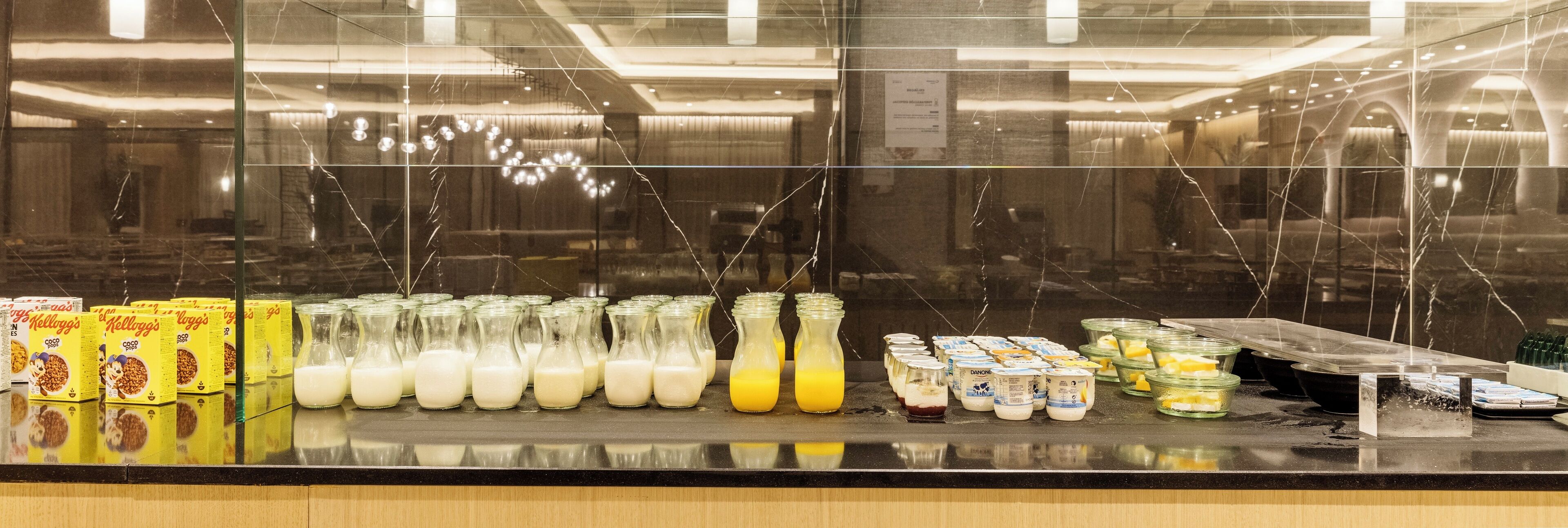 Una exhibición de cartones de leche, botellas de leche y recipientes de yogur sobre un mostrador.