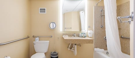 A bathroom with a toilet, sink, bathtub, and shower curtain.
