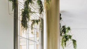 A conference room with tables, chairs, and hanging plants. - The Como Melbourne by Accor (South Yarra)