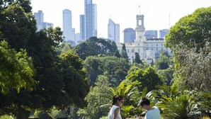 A park with a city skyline in the background, benches, and lush greenery. - The Como Melbourne by Accor (South Yarra)