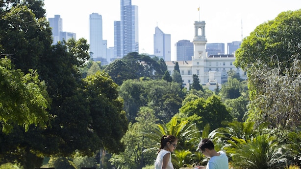 A park with a city skyline in the background, benches, and lush greenery. - The Como Melbourne by Accor (South Yarra)