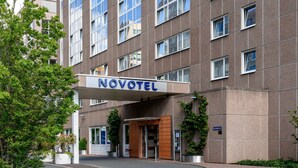 A Novotel hotel entrance with a modern facade, large windows, and a sign above the entrance. - Novotel Frankfurt City (Frankfurt)