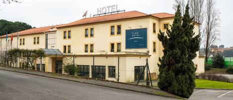 A hotel building with a sign reading "Flag Hotel."