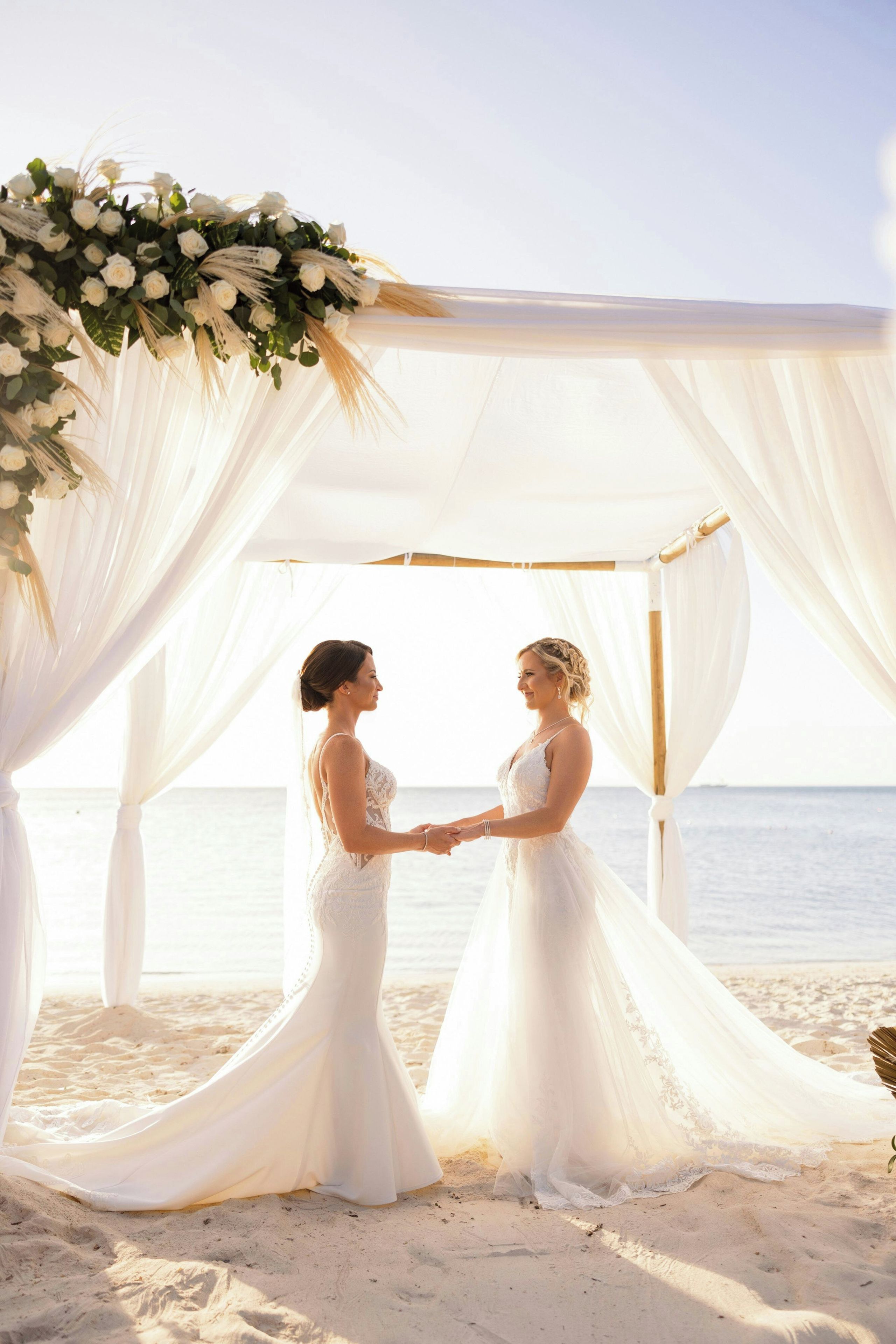 Decoración de boda en la playa, con toldo y adornos florales.