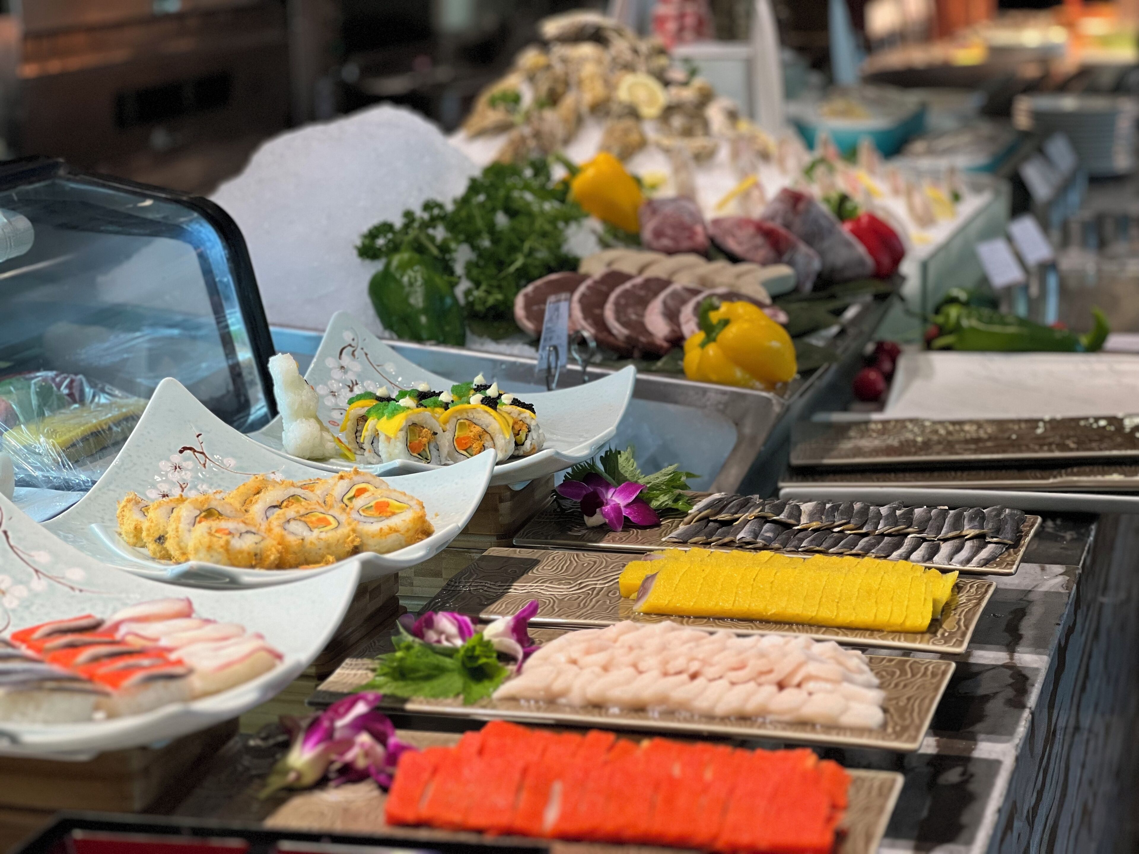 A sushi bar with various types of sushi displayed on trays.