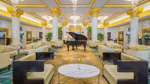 A grand lobby with marble columns, chandeliers, a grand piano, and plush seating areas. - Crowne Plaza Zhengzhou by IHG (Zhengzhou)
