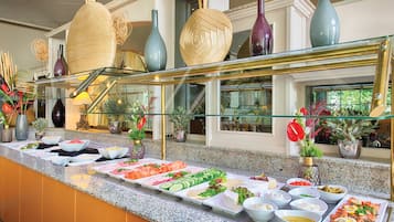 A buffet with various food items and decorative vases.