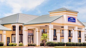 A Howard Johnson hotel with a sign indicating high-speed internet and smoking rooms available. - Howard Johnson by Wyndham Perry GA (Perry)