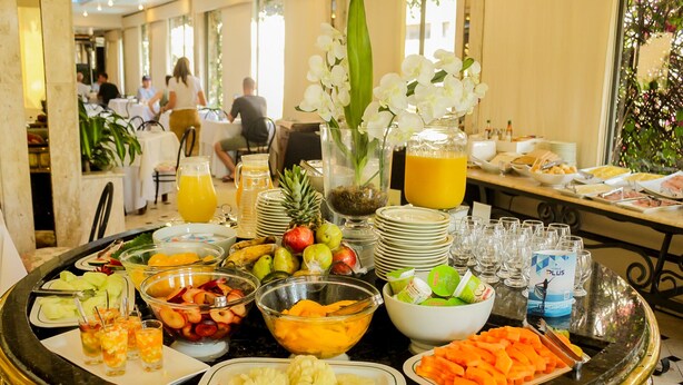 A buffet setup with various fruits, vegetables, and beverages. - Nobile Suites Excelsior Asuncion (Asunción)