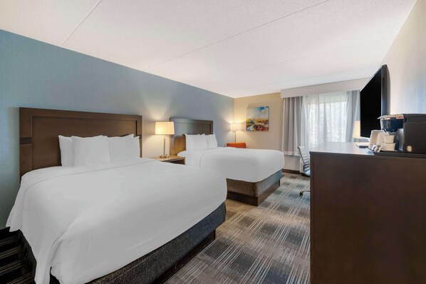 Premium bedding, desk, laptop workspace, blackout drapes