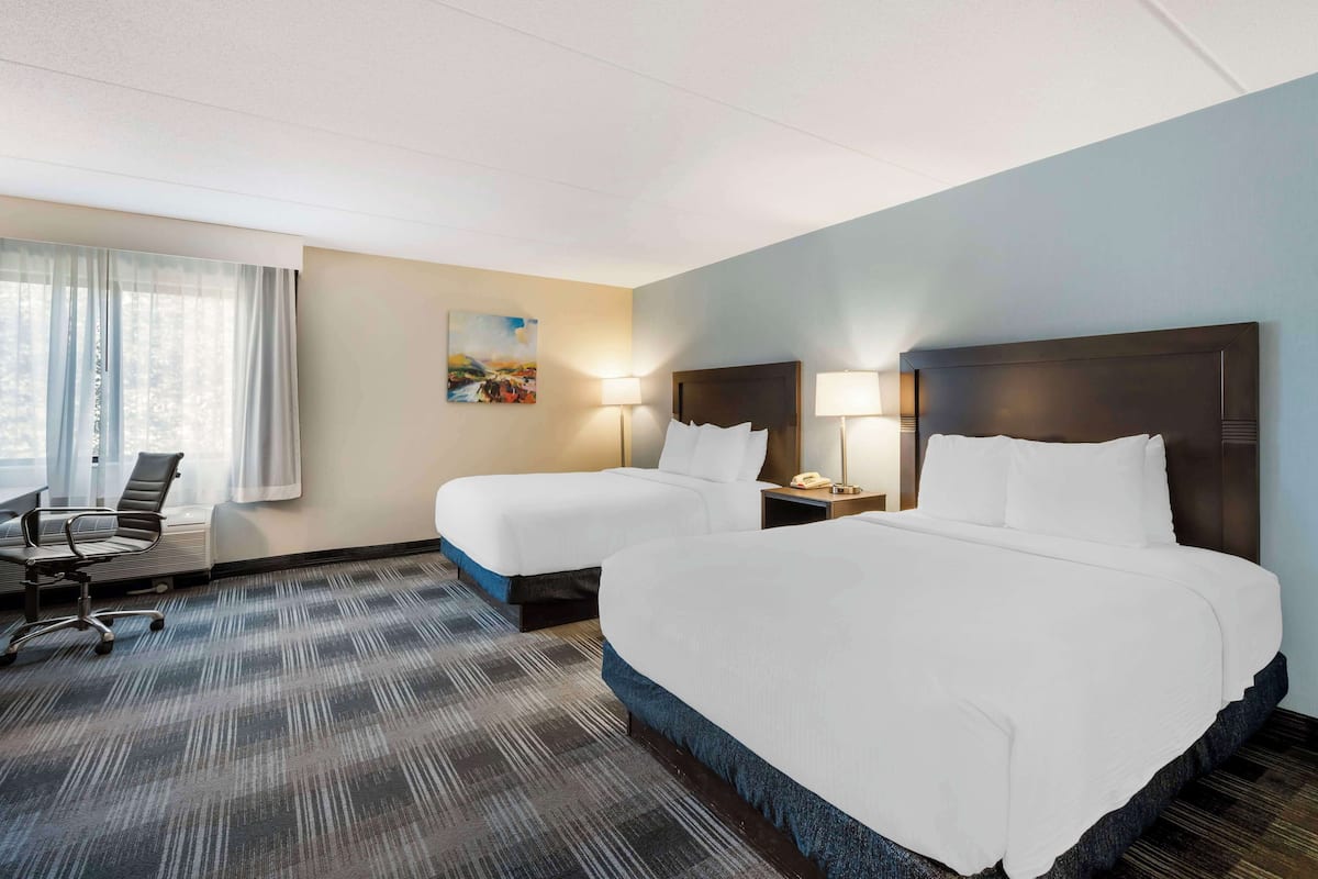 Premium bedding, desk, laptop workspace, blackout drapes