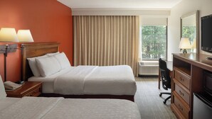 A hotel room with two beds, a desk, a dresser, a TV, and a window with curtains. - Long Creek Hotel by IHG (South Portland)