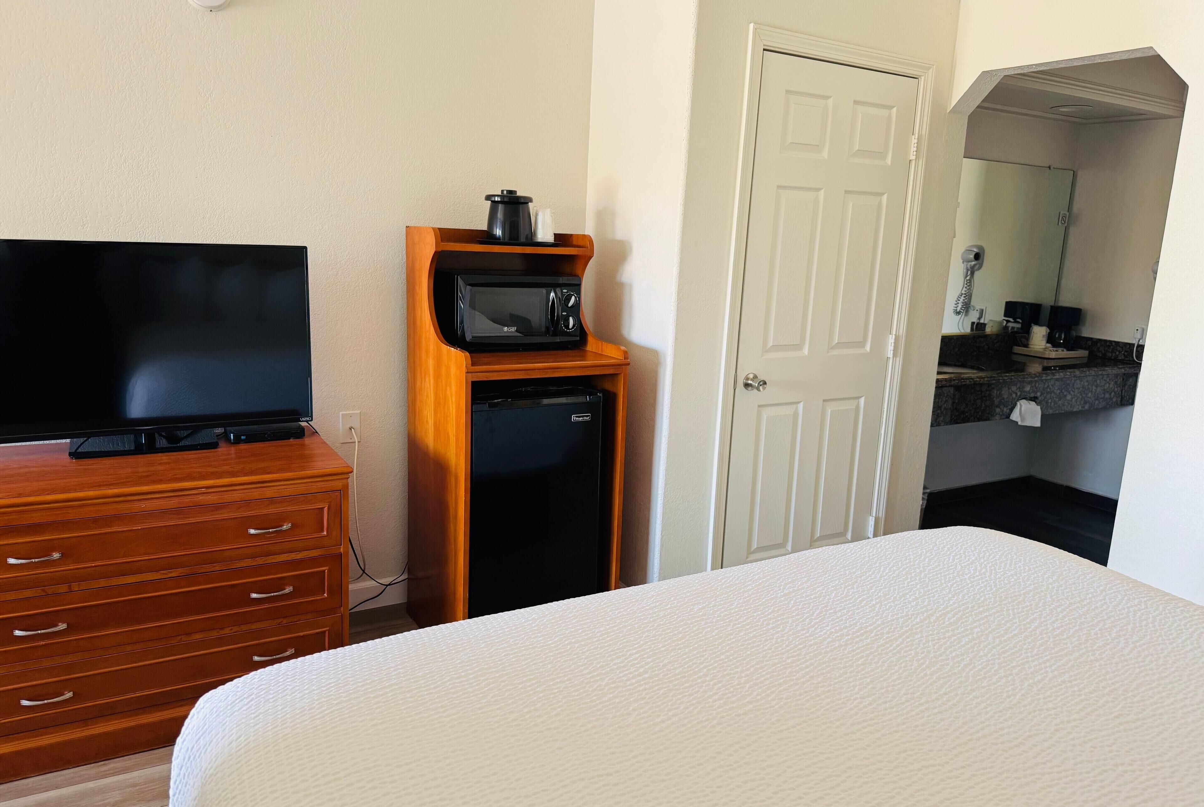 Desk, laptop workspace, blackout drapes, iron/ironing board