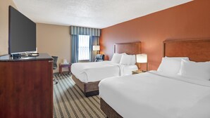 A hotel room with two beds, a desk, a TV, and a window with curtains. - Best Western Plus Inn at Valley View (Roanoke)