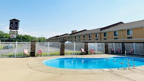 A hotel with a swimming pool, fenced areas, and a sign for the Fort Scott Inn. - Super 8 by Wyndham Fort Scott (Fort Scott)