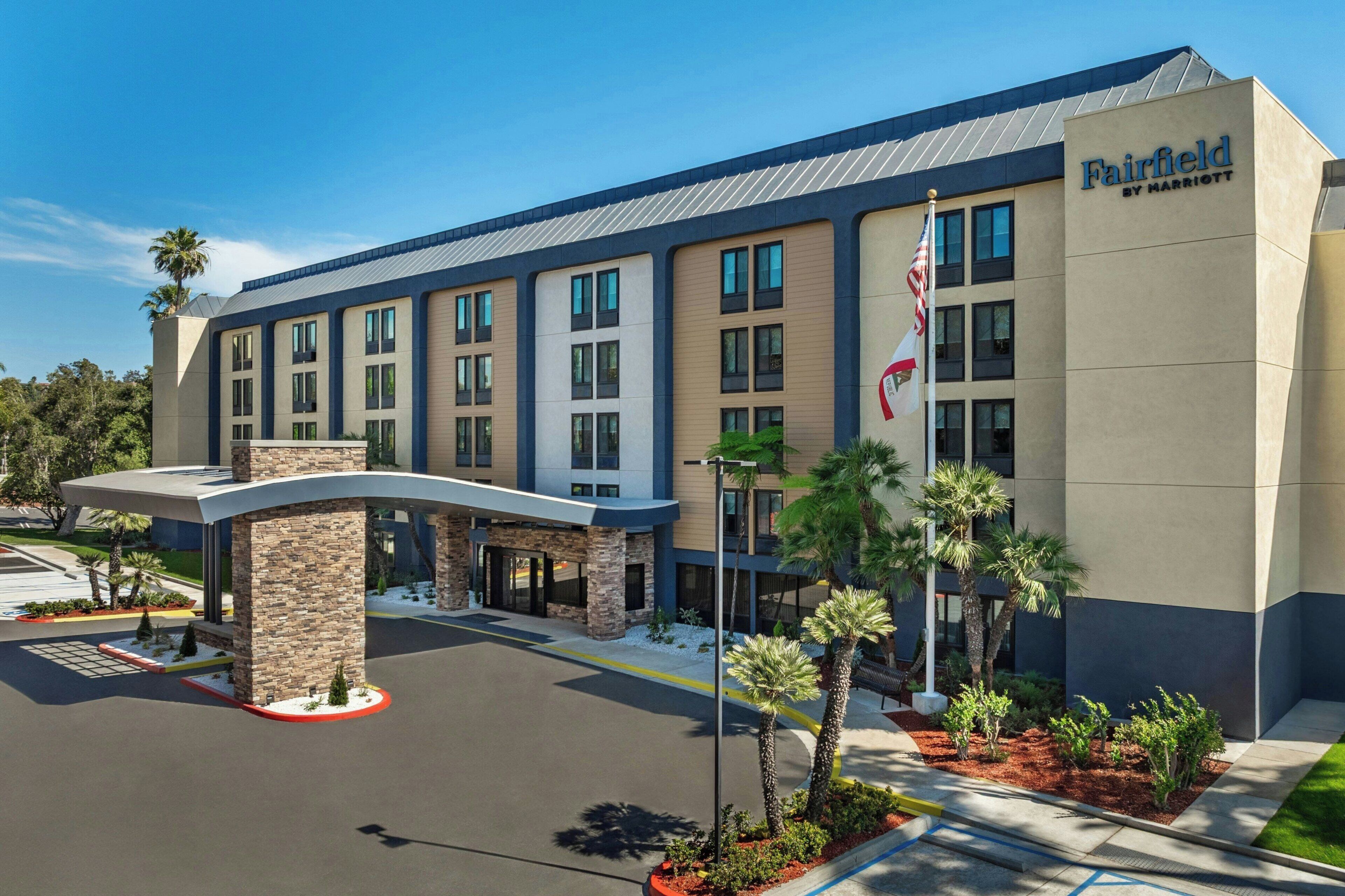 A Fairfield by Marriott hotel with a modern design, a covered entrance, and a flagpole.