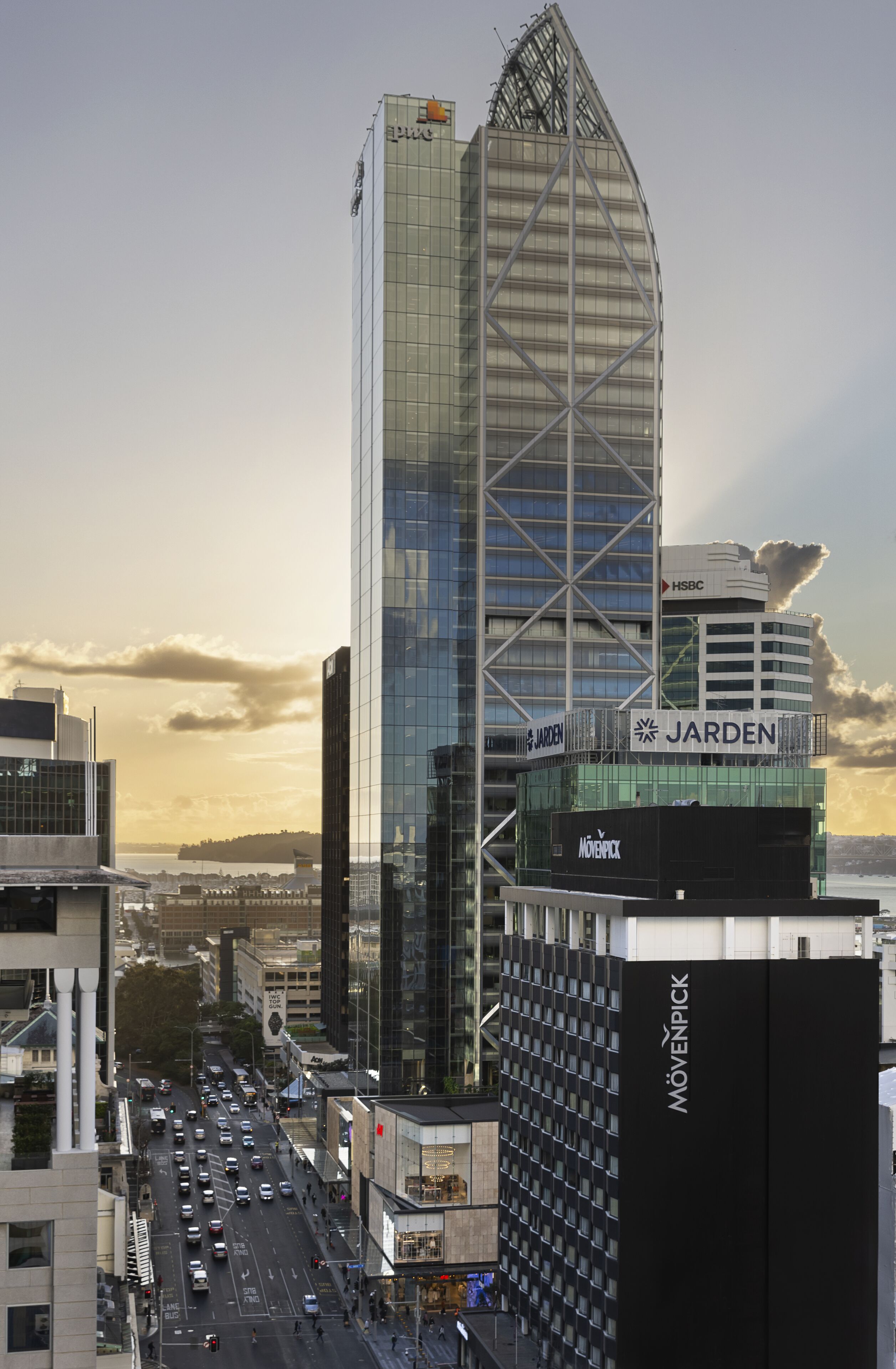 A cityscape with modern buildings, including a prominent HSBC building and a structure with 'JARDEN' signage.