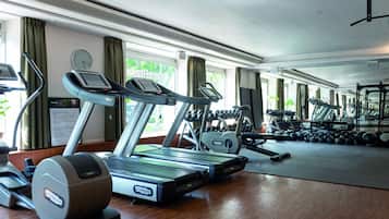 A gym with treadmills, ellipticals, and free weights.