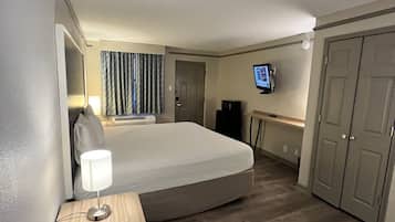 Premium bedding, desk, laptop workspace, blackout drapes