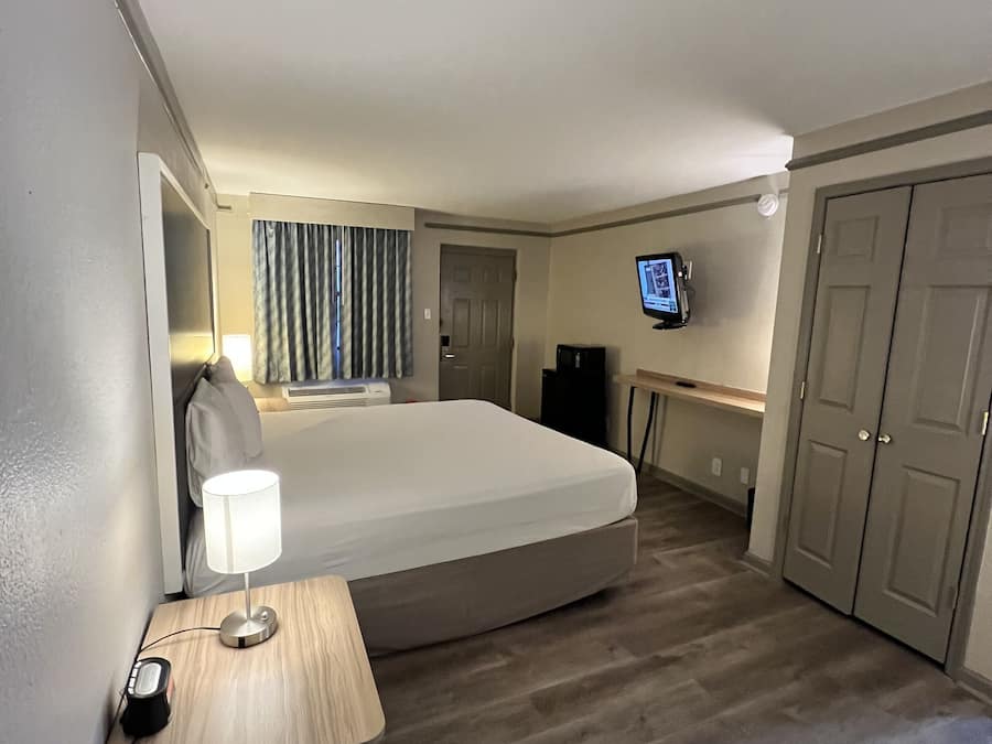 Premium bedding, desk, laptop workspace, blackout drapes