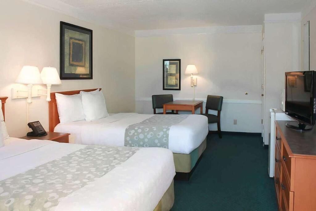 Premium bedding, desk, laptop workspace, blackout drapes