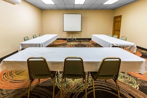 Conference room with a large table and comfortable seating for meetings and presentations.