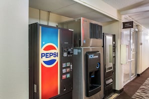 Vending machines for Pepsi and an ice dispenser in a hotel corridor.