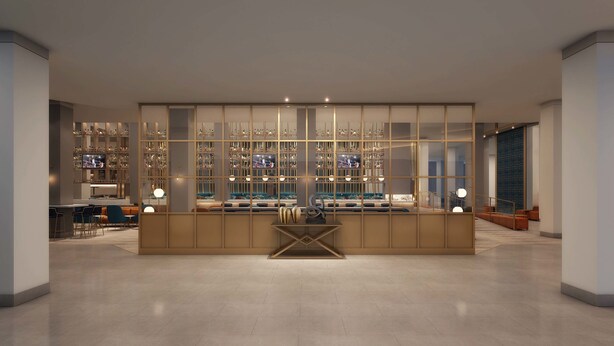 A modern bar area with a central island, multiple shelves of bottles, and a television screen.