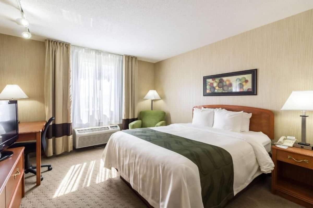 Escritorio, cortinas blackout y tabla de planchar con plancha