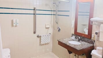 A bathroom with a sink, mirror, towel rack, and grab bars.