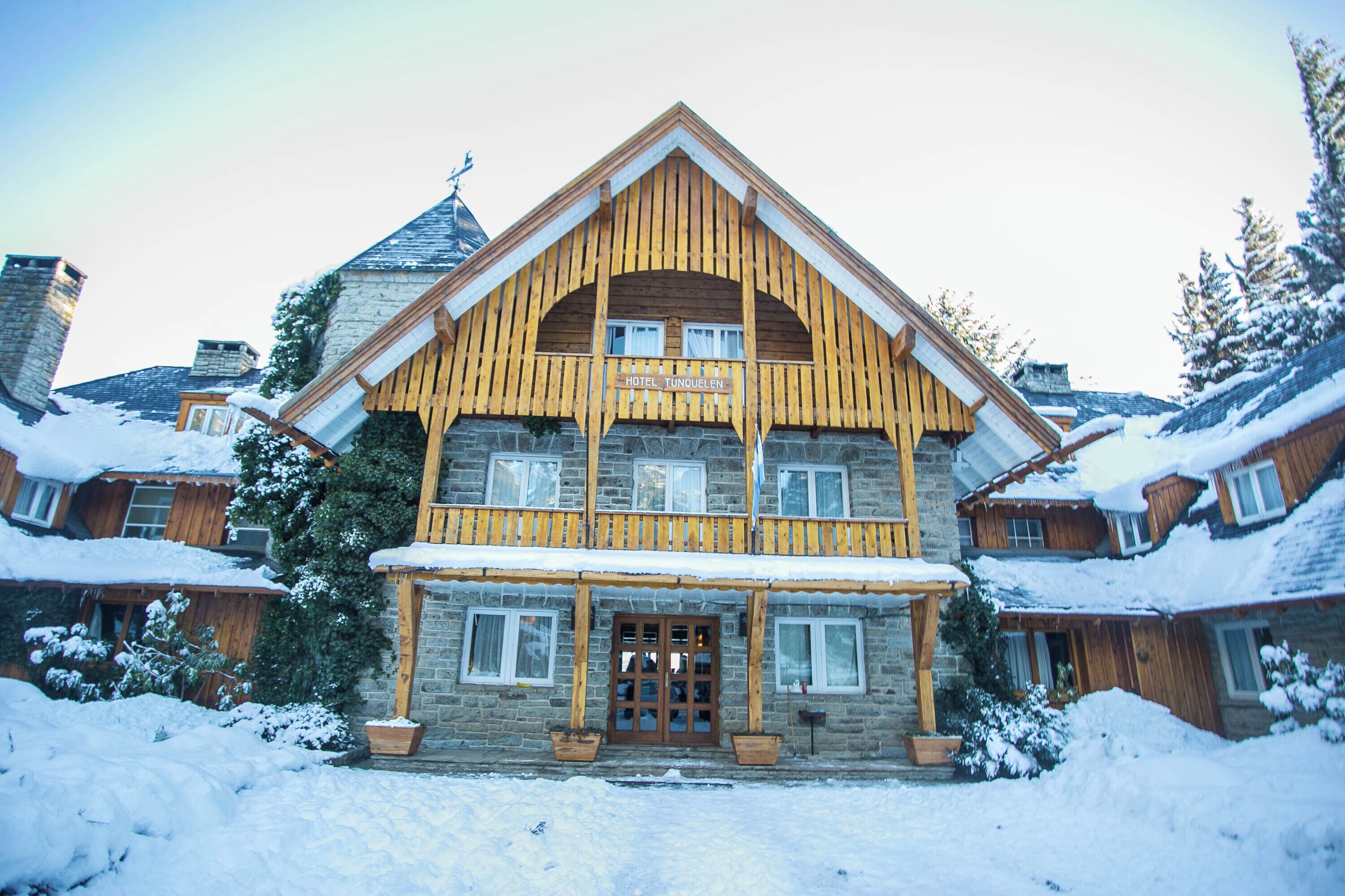 A large wooden hotel with a prominent entrance and multiple windows.