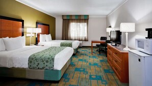 A hotel room with two beds, a desk with a TV, a microwave, and a dresser. - La Quinta Inn & Suites by Wyndham St. Pete-Clearwater Airpt (Clearwater)