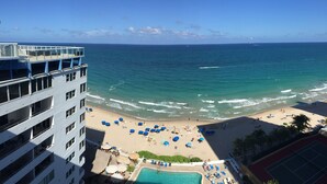 Une vue sur la plage depuis un hôtel doté d’une piscine et de chaises longues.