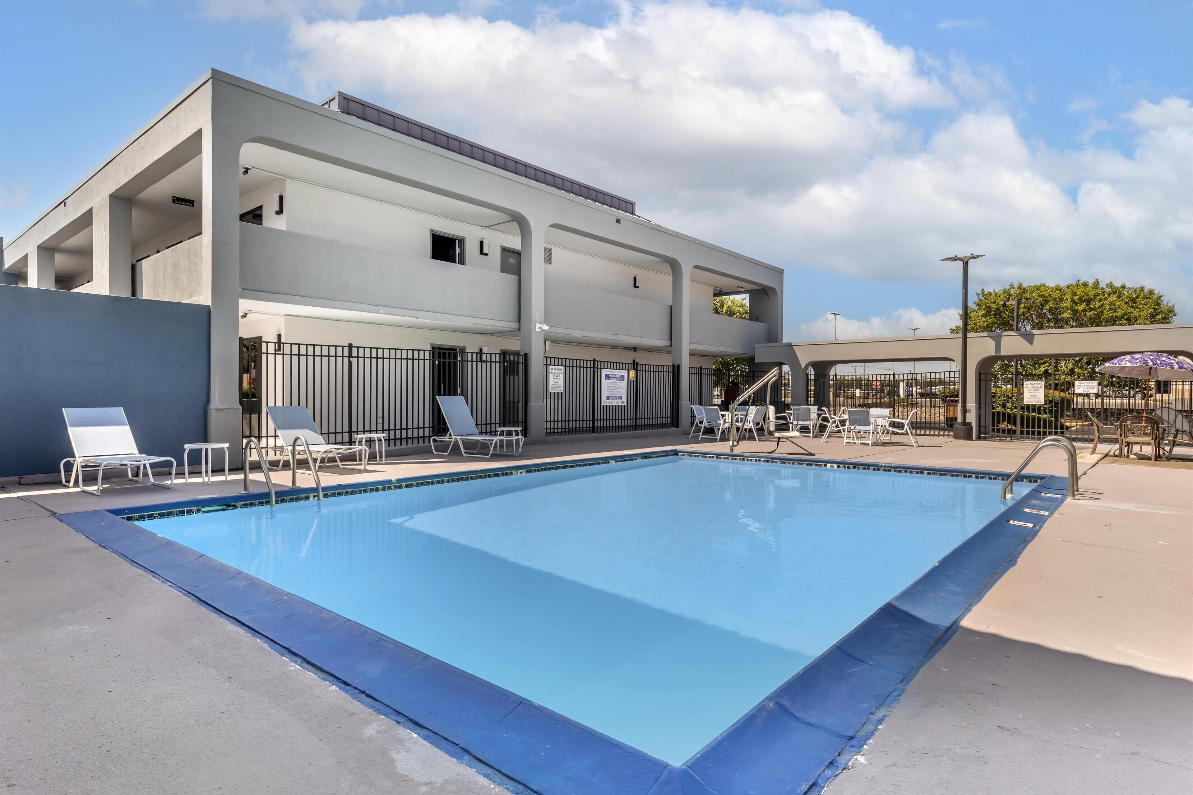 Seasonal outdoor pool, open 9:00 AM to 10:00 PM, pool umbrellas