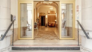 The Grand Hotel Bellevue entrance with a marble staircase and a chandelier.