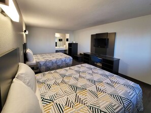A hotel room with two beds, a TV, a desk, and a mirror. - Motel 6 Wichita, KS – South I-35 (Wichita)
