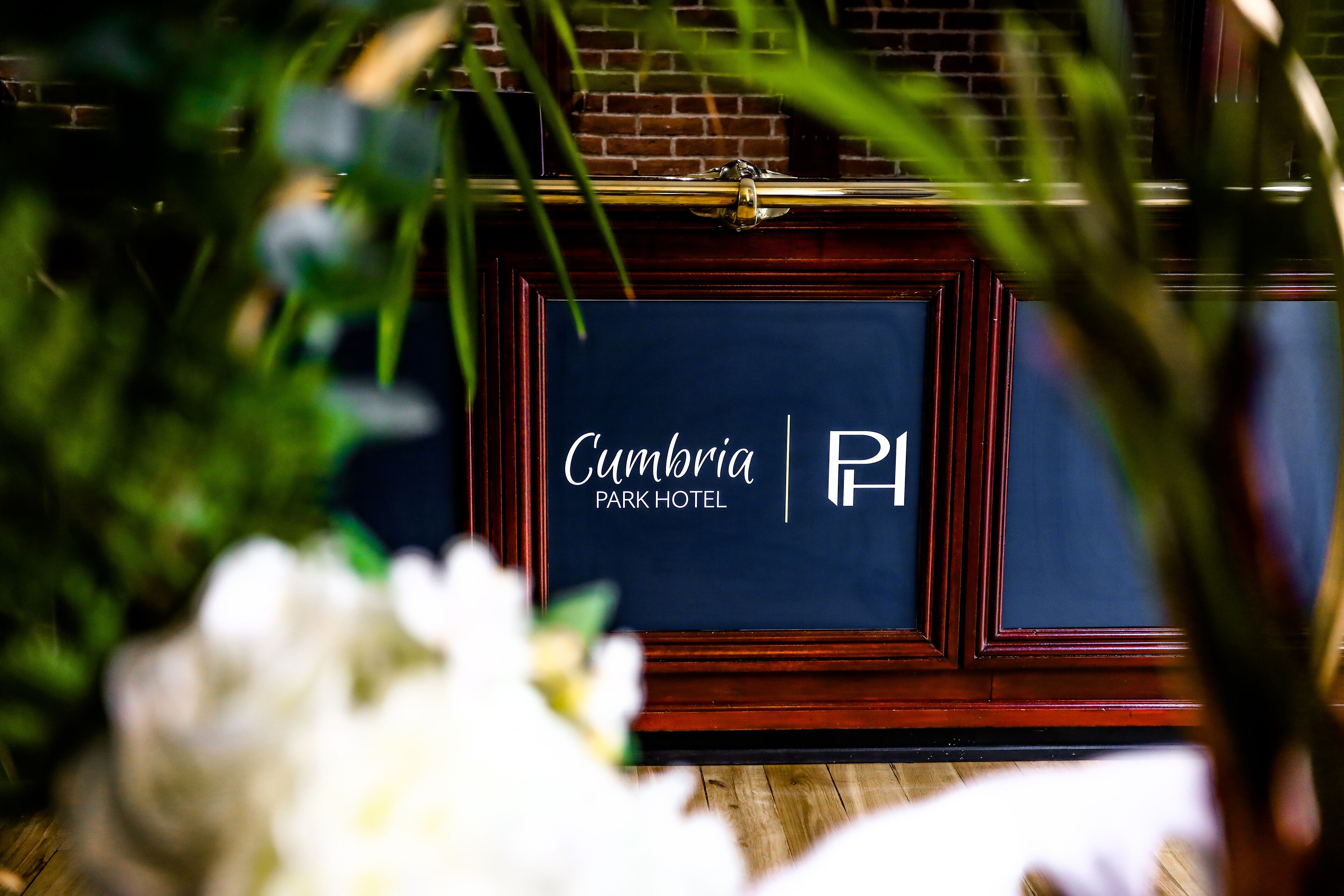 A sign for the Cumbria Park Hotel with a dark blue background and white lettering.