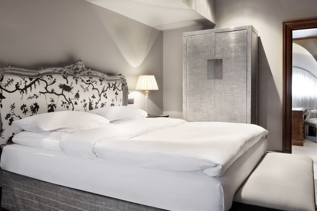 Un dormitorio moderno con una cama grande, un armario y un espejo.