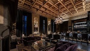 A luxurious bar area with a bar counter, seating, and a patterned ceiling. - Schlosshotel Berlin  (Berlin)