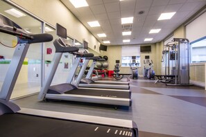 A gym with treadmills, weight machines, and a large window. - Holiday Inn St. John's Conference Centre by IHG (St. John's)