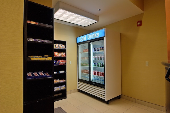 A vending machine area with a refrigerated display case labeled "Cold Drinks" containing various beverages. - Comfort Inn & Suites Statesville - Mooresville (Statesville)
