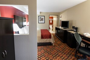 A hotel room with a bed, a desk with a computer, a TV, and a bathroom visible through an open door. - Comfort Inn & Suites Statesville - Mooresville (Statesville)