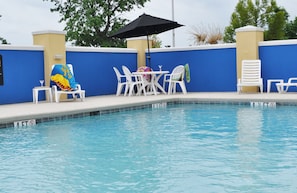 Seasonal outdoor pool, open 9 AM to 10 PM, pool umbrellas, pool loungers